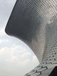 Low angle view of built structure against cloudy sky