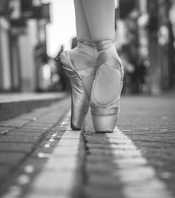 Low section of ballet dancing on footpath