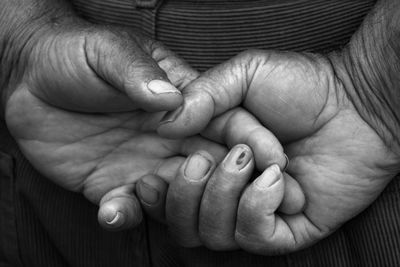 Midsection of mother and baby hands