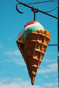 Low angle view of ice cream hanging against sky