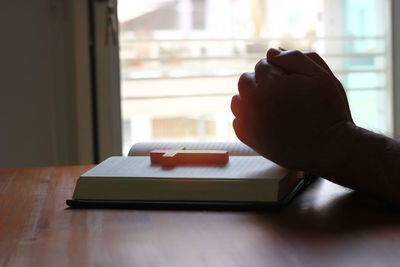 Close-up of hand holding window