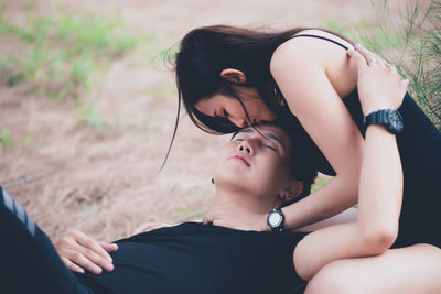 Midsection of woman sitting on a land