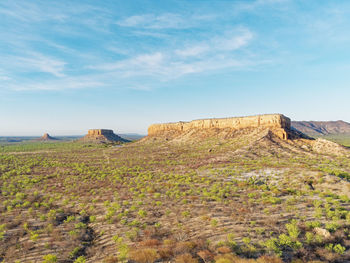 Rock formations on landscape against sky