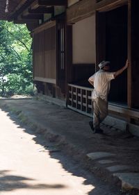 Full length of senior man in front of building