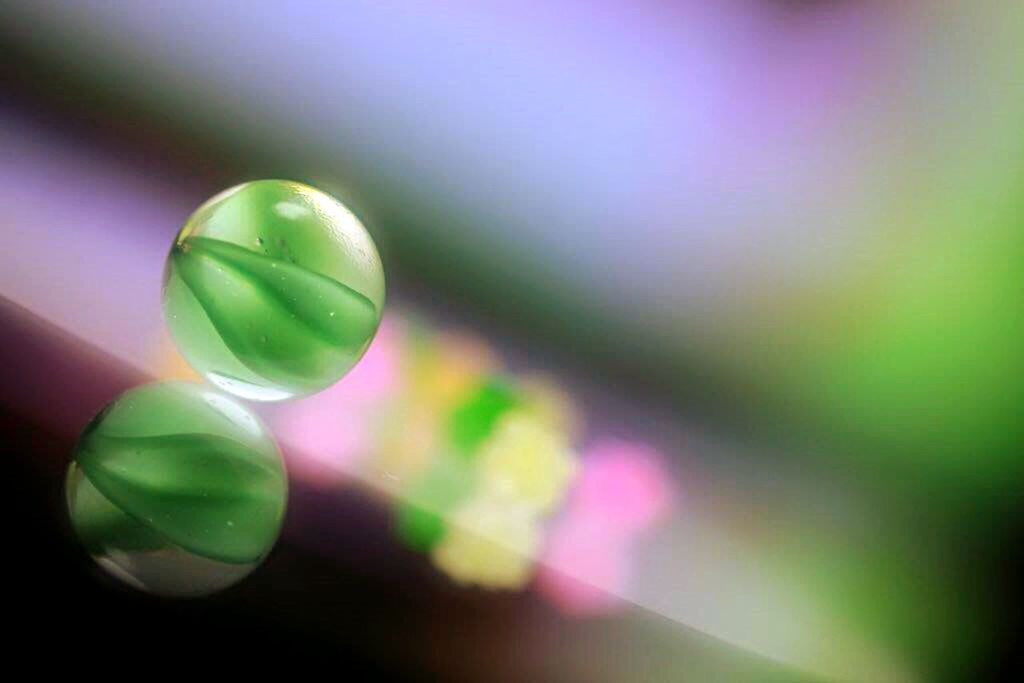 close-up, green color, multi colored, selective focus, focus on foreground, colorful, fragility, green, still life, no people, sphere, drop, indoors, defocused, bubble, day, detail, nature, reflection, variation