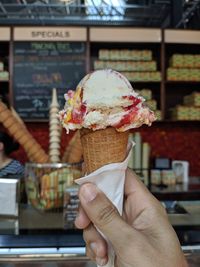 Hand holding ice cream cone