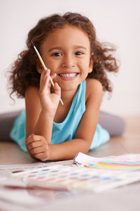 Portrait of cute girl with paint brush