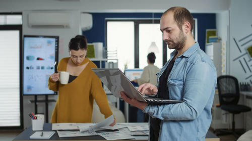 Side view of business colleagues working at office