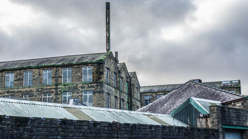 Low angle view of building against cloudy sky