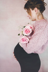 Woman holding pink rose