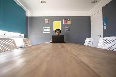 Portrait of man sitting on chair at table