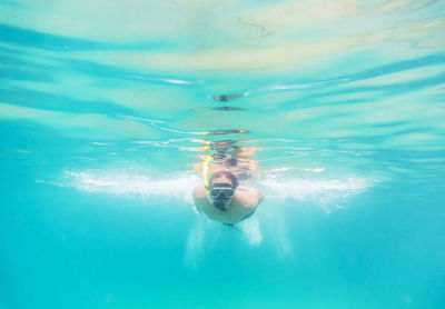 Shirtless man snorkeling in sea