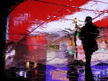 Reflection of silhouette man in water