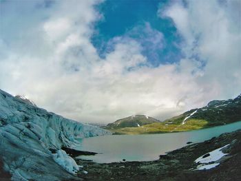 Scenic view of lake and mountains against sky