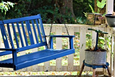 Close-up of blue table against plants