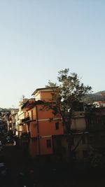 Houses and buildings against clear sky