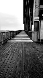 Empty footbridge against sky