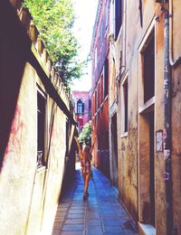 Rear view of woman walking on street in city