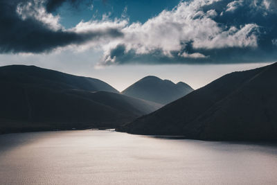 Scenic view of mountains against blue sky