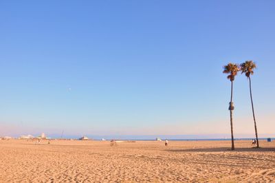 Scenic view of beach against clear blue sky