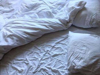 High angle view of crumpled white sheet on bed at home