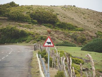 Road leading towards mountains against sky