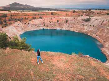 High angle view of woman standing on mountain