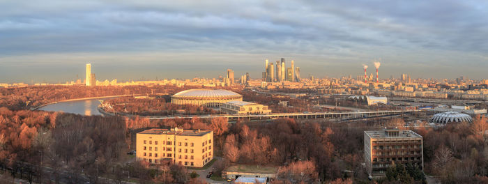 High angle view of buildings against cloudy sky