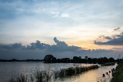 Scenic view of lake against sky during sunset