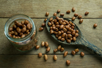 High angle view of peanut in wooden spoon on table