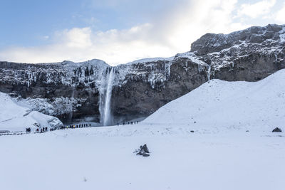 Scenic view of snow covered mountains against sky