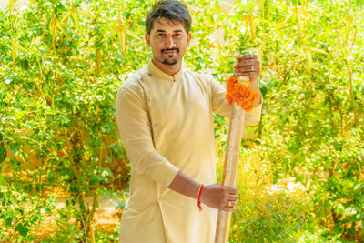 Portrait of man standing against plants