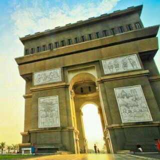 architecture, built structure, building exterior, low angle view, facade, sky, entrance, arch, history, door, sunlight, window, outdoors, building, day, travel destinations, old, architectural column, gate, city