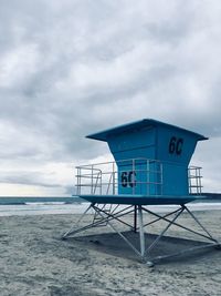 Lifeguard hut on beach against sky