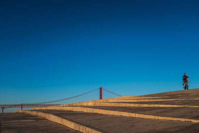 View of suspension bridge against clear blue sky