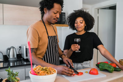 Young couple holding food at home