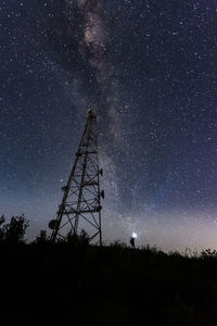 Low angle view of silhouette trees against sky at night