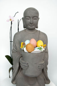 Statue of buddha against white background