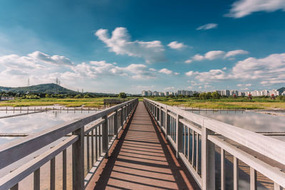 Footbridge against sky