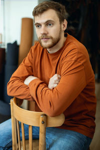 Portrait of man sitting on chair