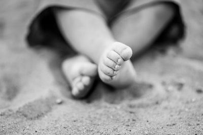 Low section of baby on sand