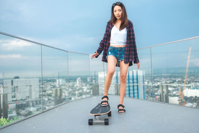 Full length of woman against sky in city