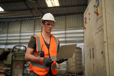 Portrait of young man working at construction site