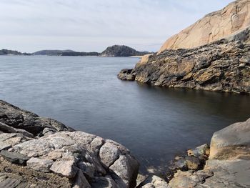 Scenic view of sea against sky with rocky shoreline 