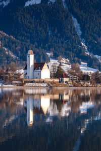 Reflection of trees and buildings on lake