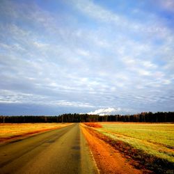 Empty road along countryside landscape