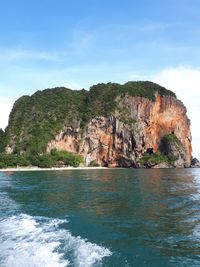 Rock formations by sea against sky