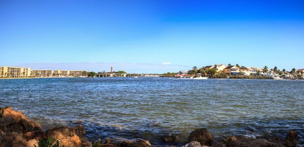 Loxahatchee river with the jupiter inlet lighthouse in the background along with boats in jupiter