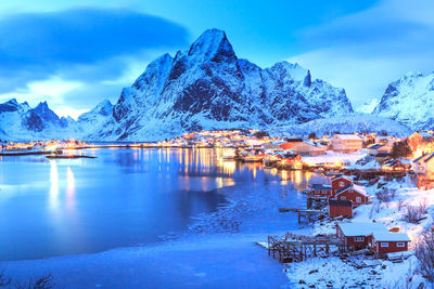 Scenic view of lake and mountains against sky during winter