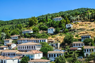 Houses on mountain against clear sky